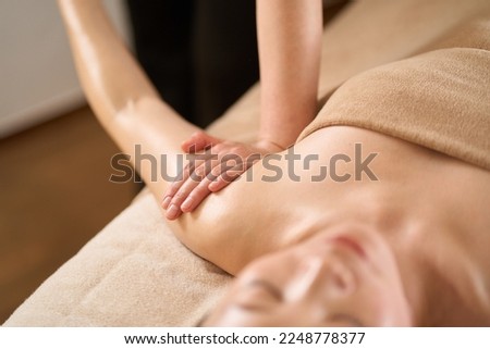 Woman receiving arm massage at beauty salon Royalty-Free Stock Photo #2248778377