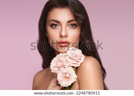 Portrait beautiful young woman with clean fresh skin. Model with healthy skin, close up portrait. Cosmetology, beauty and spa. Girl with a rose flower Royalty-Free Stock Photo #2248780411