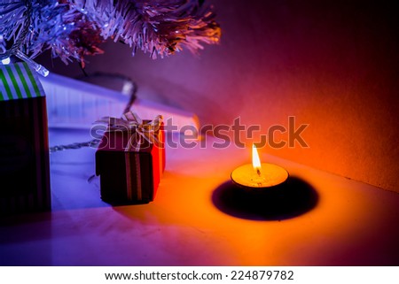 Art candle light with Christmas tree silhouette.