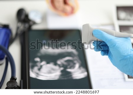 Ultrasound picture and doctor transcranial dopplerography of child in womb