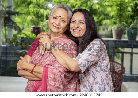 Portrait of happy young indian daughter hug her mother at home, Love and bonding, Asian family. looking camera. Royalty-Free Stock Photo #2248805745