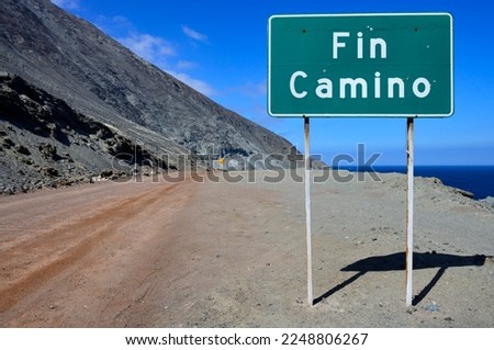 Warning sign at the end of the road on the rocky coast, near Antofagasta, Región de Antofagasta, Chile