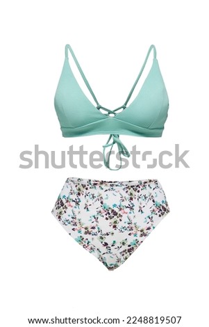 Close-up shot of a two-tone bikini set with back ties. A two-piece swimsuit with a floral print is isolated on a white background. Front view.