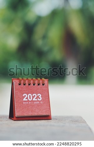 close up red small calendar on table, planning and manage time for future, happy new year and holiday season wallpaper background concept