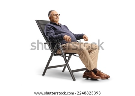Mature man resting seated in a foldable chair isolated on white background Royalty-Free Stock Photo #2248823393