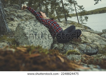 Relax mind with nature scenic photography. Picture of woman stretching, leaning back to rock with landscape on background. High quality wallpaper. Photo concept for ads, travel blog, magazine, article