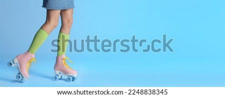 Woman with vintage roller skates on color background, closeup. Space for text. Banner design
