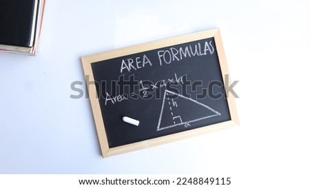 Blackboard with hand written geometry area formulas and geometric shapes and figures