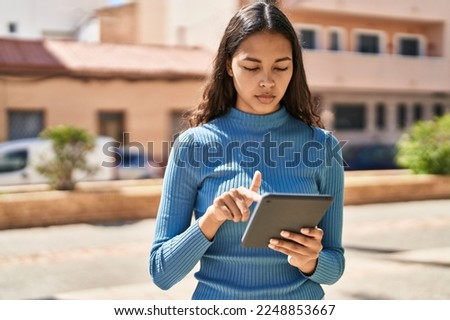 Young african american woman using touchpad at park