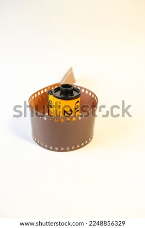 A roll of 35mm. film on a white background.