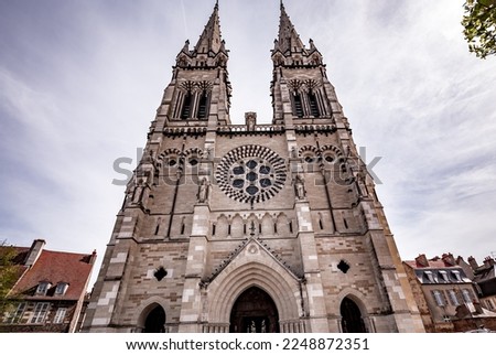 MOULINS, ALLIER, FRANCE, APRIL 11, 2022 : exteriors and architectural decors of Cathedral of Our Lady of the Annunciation, by various architects, from 15 th to 19th century Royalty-Free Stock Photo #2248872351