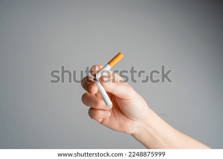 Stop smoking, quit smoking or no smoking cigarettes. Woman holding broken cigarette in hands. Woman refusing cigarettes and lung health concept. Royalty-Free Stock Photo #2248875999