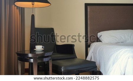 Round table, chair and standing lamp, design interior of living and bedroom in the house
