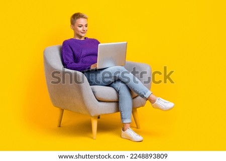 Full size photo of pretty positive girl sit chair use wireless netbook coworking isolated on yellow color background