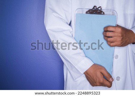 A doctor carrying a document, patient lists.