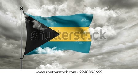The Bahamas national flag cloth fabric waving on beautiful grey sky.