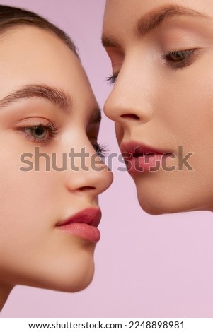 Portrait of two young, beautiful blonde and brunette girls with well-kept skin isolated over pink studio background. Concept of skincare, cosmetology, natural beauty, youth, spa, cosmetics. Ad Royalty-Free Stock Photo #2248898981
