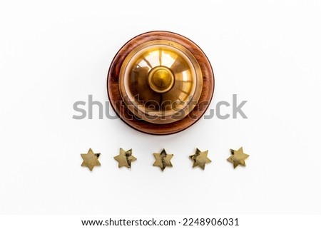 Hotel service bell with five golden stars, top view Royalty-Free Stock Photo #2248906031