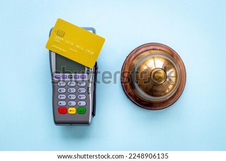Vintage hotel service bell with payment terminal and credit cards
