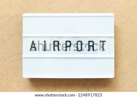 Lightbox with word airport on wood background