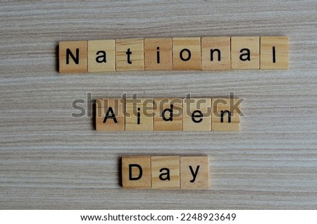 National aiden day text on wooden square, holiday quotes