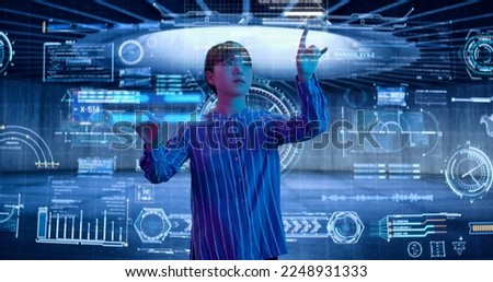 Female Scientist Analyzing a Digital Data, Touching an Invisible. Holographic Screen. Asian Woman, Business Reviews the Statistics and Moving Animated Virtual Graphs and Table Data. High quality photo
