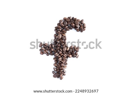 Coffee beans in the shape of isolated on a white background.Heart made of coffee beans on black concrete background.