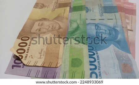 Indonesian Rupiah, one hundred thousand rupiah and one hundred thousand rupiah in cash.