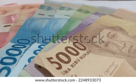 Indonesian Rupiah, one hundred thousand rupiah and one hundred thousand rupiah in cash.