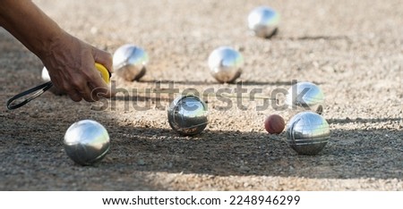 Petanque game, woman measuring the distance of petanque ball in petanque field, deciding who's the winner Royalty-Free Stock Photo #2248946299