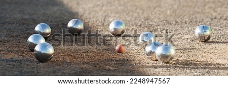 Petanque balls boules bowls on closeup on sand gravel court background, game of petanque on the ground. Balls and a small wood jack Royalty-Free Stock Photo #2248947567