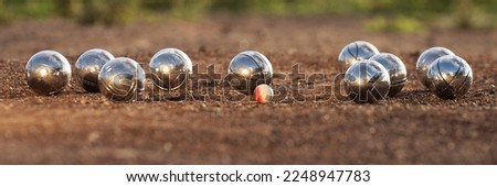 Petanque balls boules bowls on closeup on sand gravel court background, game of petanque on the ground. Balls and a small wood jack Royalty-Free Stock Photo #2248947783
