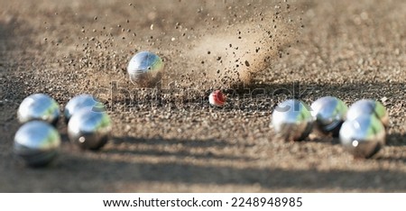 Petanque ball boules bowls on a dust floor, photo in impact. Game of petanque on the ground. Balls and a small wood jack Royalty-Free Stock Photo #2248948985