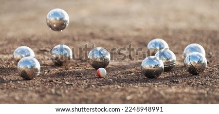 Petanque ball boules bowls on a dust floor, photo in impact. Game of petanque on the ground. Balls and a small wood jack Royalty-Free Stock Photo #2248948991
