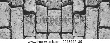 Retro Vintage Weathered Distressed Brick wall with Damaged Surface. Symmetrical Wide Web  Banner Backdrop background. Black and white Pattern. Panoramic Format