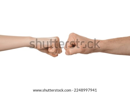Man's and woman's fists near each other, about to fist bump. Fight, clash, conflict concept. Royalty-Free Stock Photo #2248997941