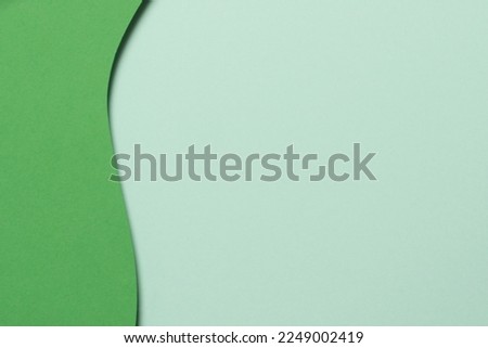 Abstract green color paper texture background. Minimal paper cut style composition with layers of geometric shapes and lines in green tone shades. Top view Royalty-Free Stock Photo #2249002419