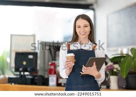 Opening a small business, AHappy Asian woman in an apron standing near a bar counter coffee shop, Small business owner, restaurant, barista, cafe, Online, SME, entrepreneur, and seller concept