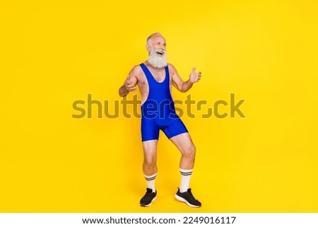 Full length portrait of excited cheerful aged man look empty space laughing isolated on yellow color background