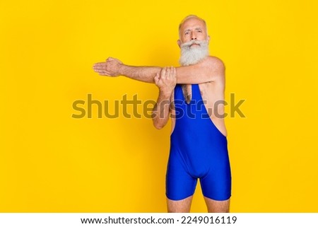 Photo of old pensioner age senior hold arm preparing warmup before practicing training professional coach confident isolated on bright yellow color background