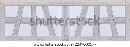 Bright half-timbered panorama - light gray wooden beams and white spaces with painted on frames Royalty-Free Stock Photo #2249030577