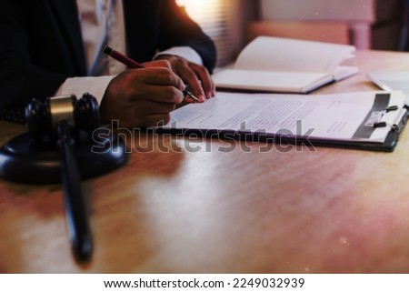 hand of business people sign contract with justice hummer on table Royalty-Free Stock Photo #2249032939