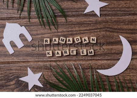 Ramadan kareem word with islamic ornaments on wooden background 
