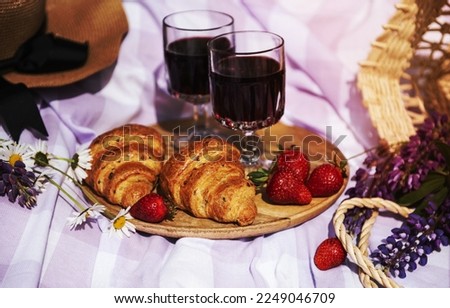 Romantic picnic scene on summer day. Outdoor picnic with wine and a fruit in the open air on the background of green grass.
