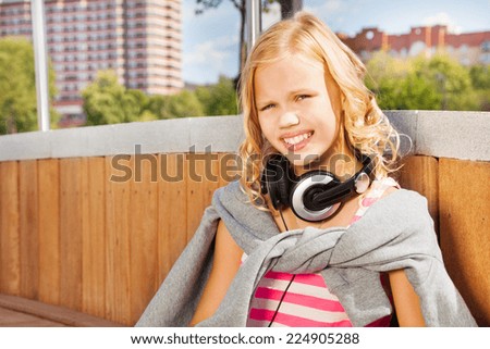 Close view of girl wearing headphones, sweatshirt