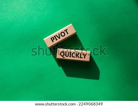 Pivot quickly symbol. Wooden blocks with words Pivot quickly. Beautiful green background. Business and Pivot quickly concept. Copy space.