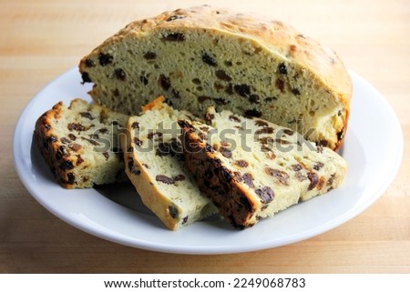 Freshly baked and sliced Irish soda bread set on a white plate. Royalty-Free Stock Photo #2249068783