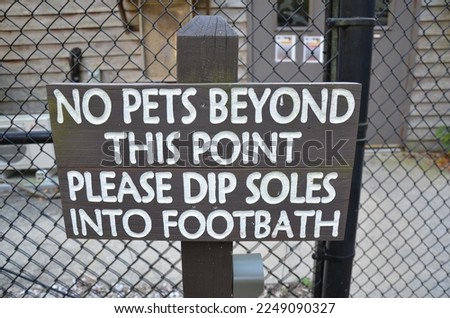 no pets beyond this point use footbath sign on fence
