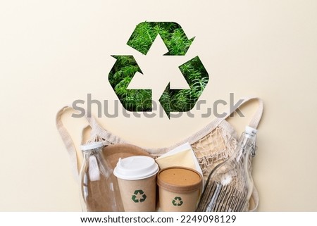 The concept of ecology and zero waste. Recycling sign and eco-friendly items made from biodegradable materials Royalty-Free Stock Photo #2249098129