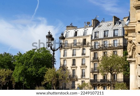 Old beautiful Parisian buildings near Buttes Chaumont park in the 19th arrondissement in Paris.